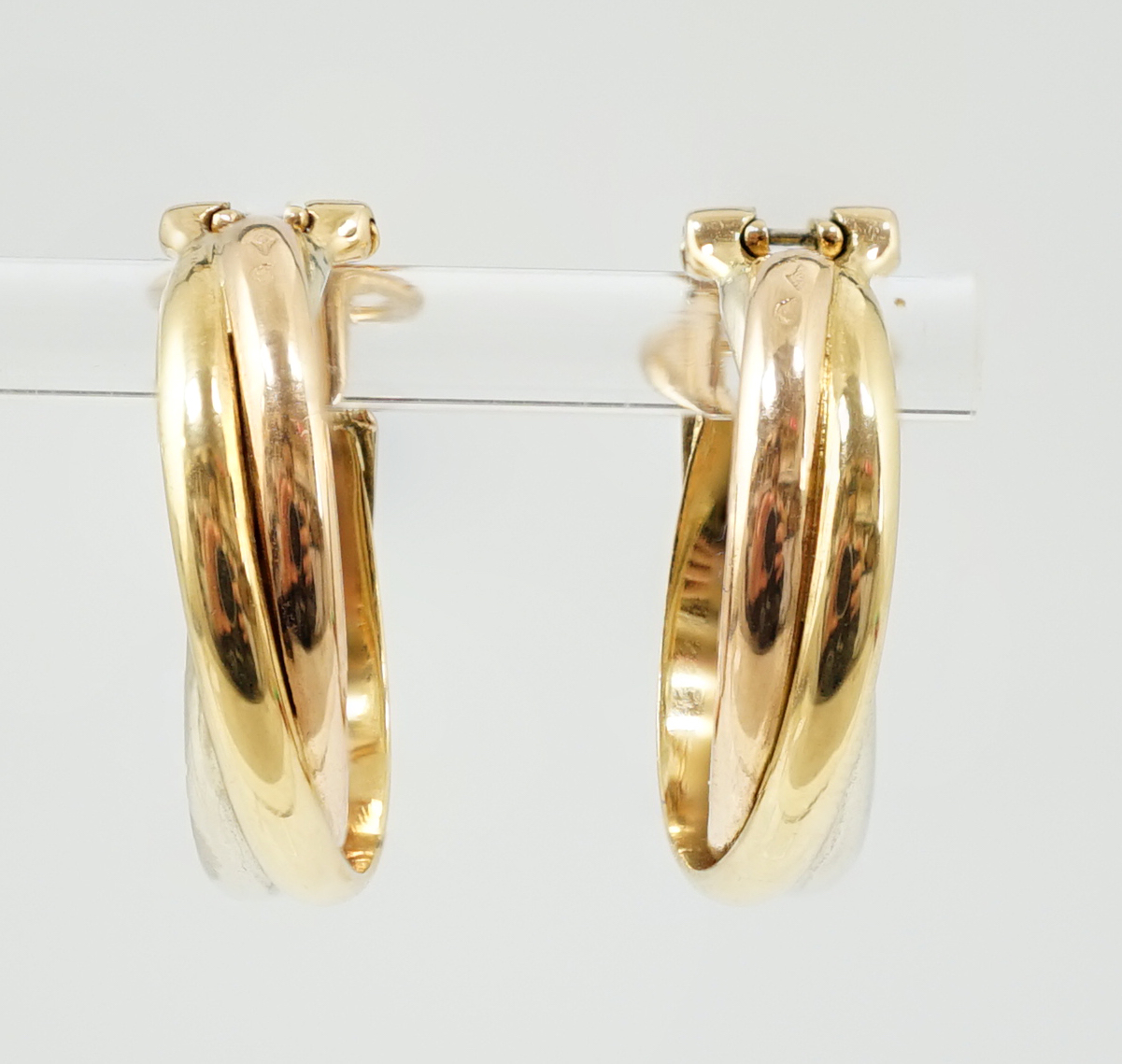 A pair of French Cartier three colour 18ct gold interwoven hoop ear clips